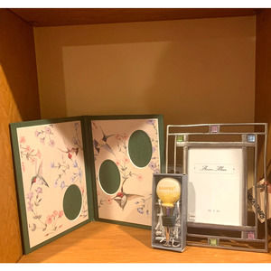 Two picture frames and a hooray bottle stopper